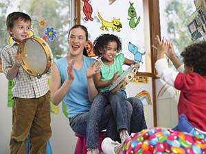 Photo of kids with teacher playing music