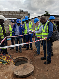 Project staff inspect the construction of a new sewer line in Mtendere, a township of Lusaka.